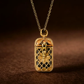 Gold pendant necklace with intricate design on a brown background
